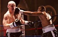 two boxers fighting in a boxing ring